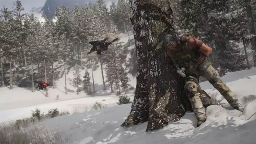 Солдат прячется за деревом, а дрон летит рядом в Tom Clancy's Ghost Recon Breakpoint