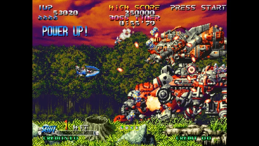 Геймплей Blazing Star с изображением битвы с гигантским роботом и надписью 'POWER UP!'