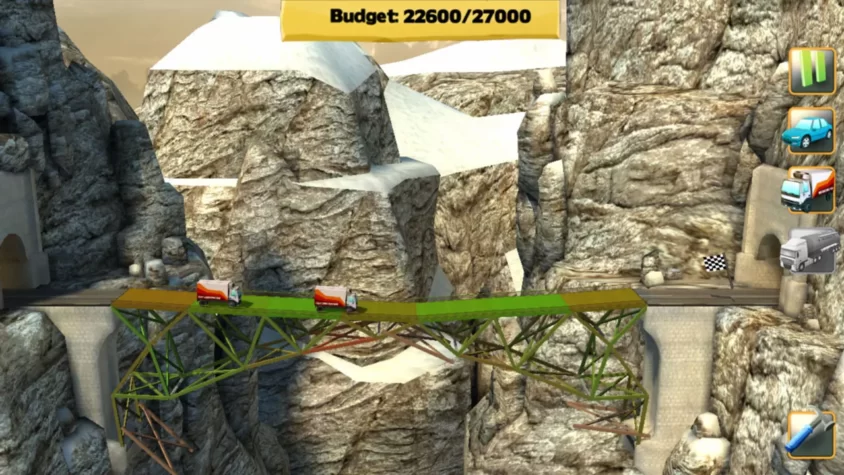 Мост в Bridge Constructor с грузовиками на фоне гор и ограниченным бюджетом