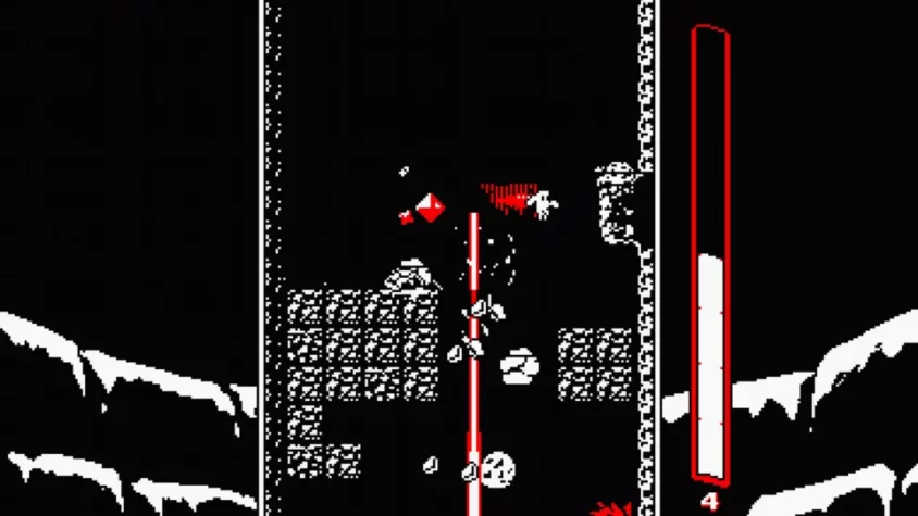 Геймплей игры Downwell, где игрок сражается с врагами в темном тоннеле