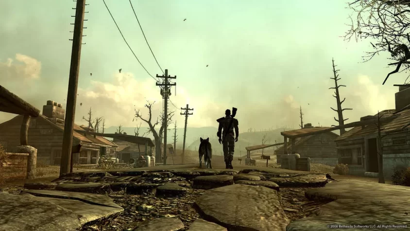 Персонаж с собакой шагает по разрушенному поселению в Fallout 3