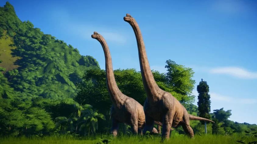 Два динозавра Брахиозавра на фоне зелёного ландшафта в Jurassic World Evolution