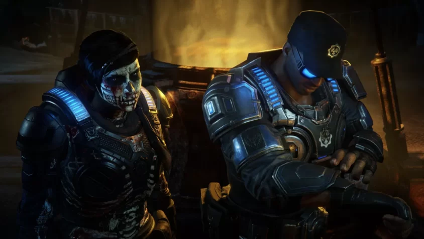 Персонажи Gears 5 стоят рядом, один с лицом в крови, другой сосредоточен на своих делах