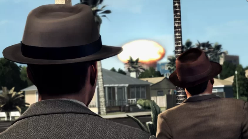Два героя L.A. Noire наблюдают за взрывом на фоне калифорнийских домов, явно не удивившись очередной катастрофе