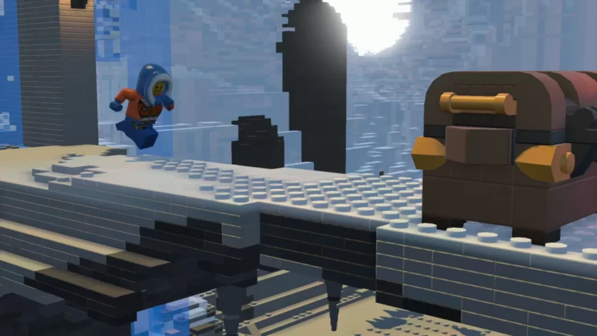 Персонаж Lego в зимнем костюме прыгает через мост на фоне снежного пейзажа с сундуком