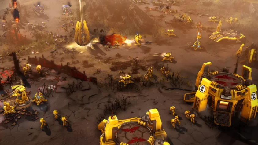 Желтые войска сражаются на пепелище, оружие и техника в битве в Warhammer 40,000: Dawn of War III
